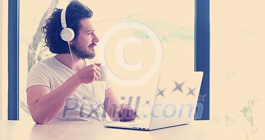 Real man Using laptop At Home Drinking Coffee Enjoying Relaxing