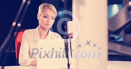 young female entrepreneur working on laptop computer in night office