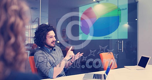Group of a young business people discussing business plan at modern startup office building