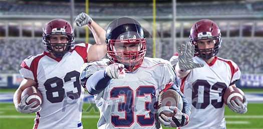 Portrait of American football player pointing against gray background Portrait of American football player pointing against gray background