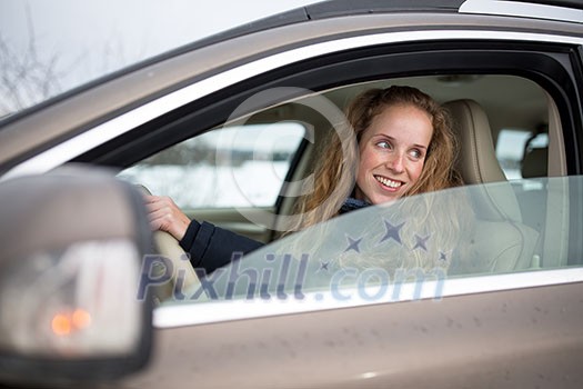 Pretty young woman driving her new car (shallow DOF; color toned image) Pretty young woman driving her new car (shallow DOF; color toned image)