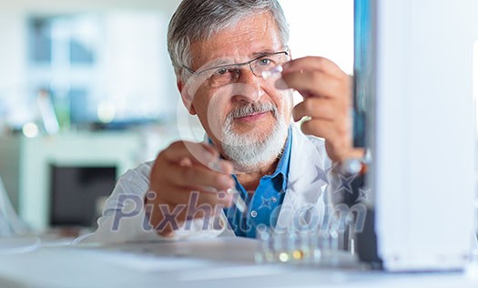 Senior chemistry professor/doctor carrying out research experiments in an analytical chemistry lab (color toned image) Senior chemistry professor/doctor carrying out research experiments in an analytical chemistry lab (color toned image)