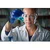 Female researcher carrying out scientific research in a lab (shallow DOF; color toned image)