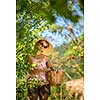 Young woman up on a ladder picking apples from an apple tree on a lovely sunny summer day