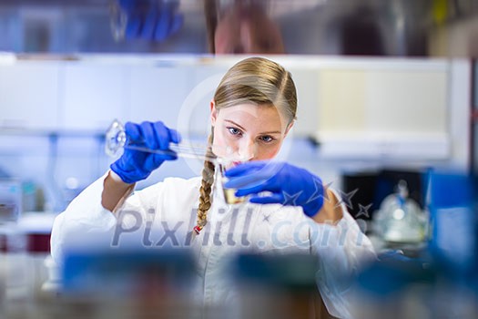 Portrait of a female researcher carrying out research in a chemistry lab (color toned image; shallow DOF)