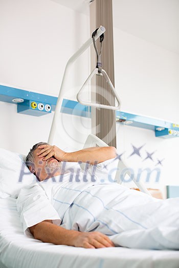 Patient in hospital room - suffering from pain after surgery