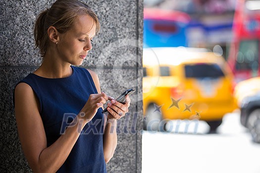 Pretty, young businesswoman talking on the phone in front of a modern building in Manhattan (shallow DOF; color toned image) Pretty, young businesswoman talking on the phone in front of a modern building in Manhattan (shallow DOF; color toned image)