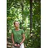Pretty, young woman nordic walking on a forest path, taking in the fresh air, getting the daily dose of exercise