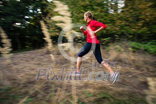 Young woman running outdoors in a forest, going fast (motion blurred image) Young woman running outdoors in a forest, going fast (motion blurred image)