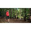 Young woman running outdoors in a forest, going fast (motion blurred image)