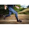 Young man running outdoors in a forest, going fast (motion blurred image)