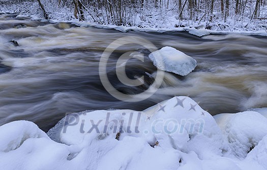 Flowing river in winter Flowing river in winter