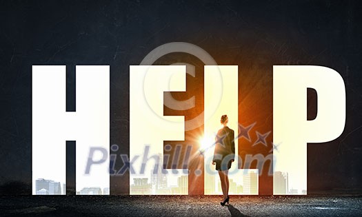 Back view of businesswoman standing in light word help Back view of businesswoman standing in light word help