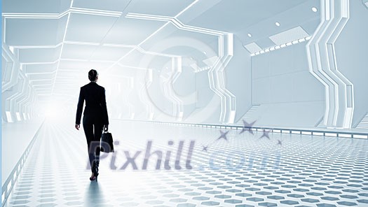 Businesswoman standing in virtual designed tunnel room Businesswoman standing in virtual designed tunnel room