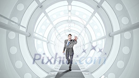Young screaming businessman running in futuristic tunnel