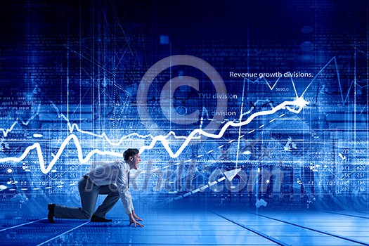 Young determined businessman standing in start position ready to compete Young determined businessman standing in start position ready to compete