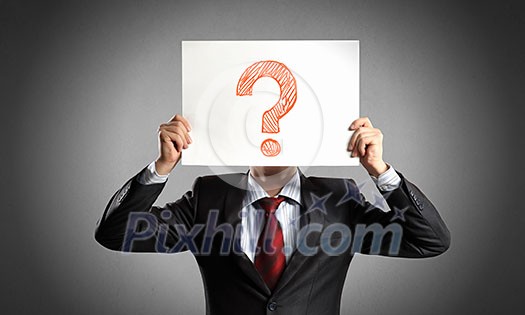 Businessman holding paper sheet with question mark in front of his face Businessman holding paper sheet with question mark in front of his face