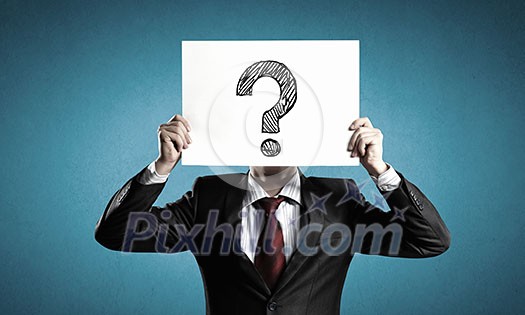Businessman holding paper sheet with question mark in front of his face Businessman holding paper sheet with question mark in front of his face