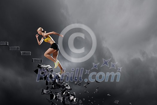 Sports active woman running on stone collapsing ladder Sports active woman running on stone collapsing ladder