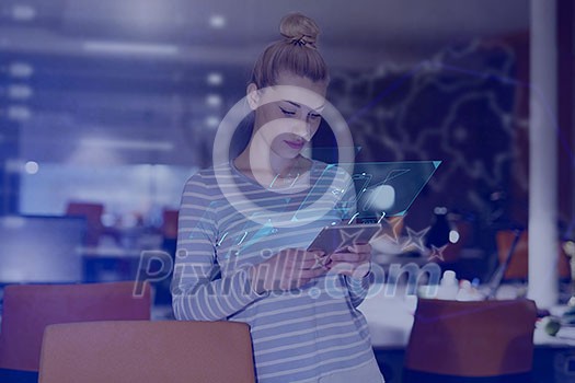 young female entrepreneur working on digital tablet in night office young female entrepreneur working on digital tablet in night office
