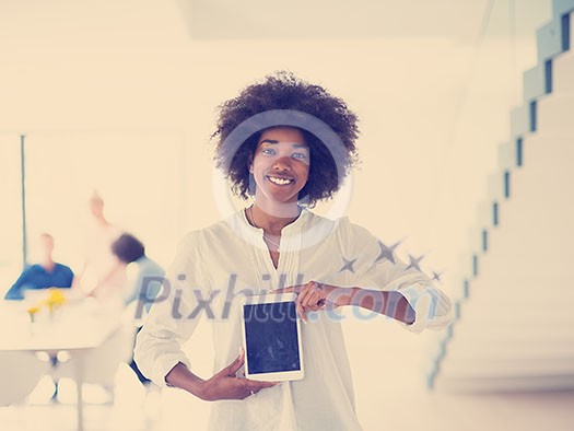 african american Businesswoman using tablet with coworkers in backgorund having meeting african american Businesswoman using tablet with coworkers in backgorund having meeting