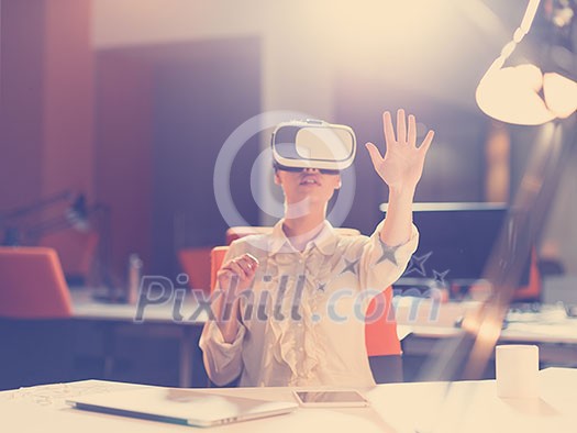 young businesswoman getting experience using VR-headset glasses of virtual reality at late night startup office building young businesswoman getting experience using VR-headset glasses of virtual reality at late night startup office building