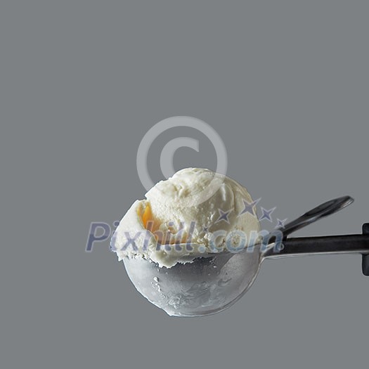 Close-up delicious dairy dessert cold white vanilla in a metal spoon for ice cream on a gray background. Summer concept. Space for text. Close-up delicious dairy dessert cold white vanilla in a metal spoon for ice cream on a gray background. Summer concept. Space for text.
