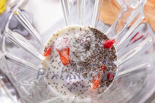 Mixed berries with yoghurt and chia seeds in a blender, top view. Superfoods and healthy lifestyle or detox diet food concept.