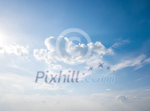 White fluffy clouds and bright sunshine on a blue sky. Concept of summer background