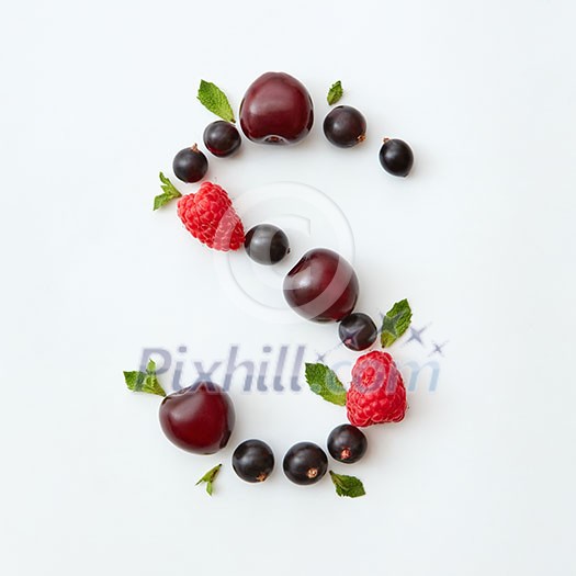 Letter S english alphabet in the form of a pattern of natural organic berries - ripe fresh raspberry, black currant, cherry, green mint leaf isolated on a white background. Top view.