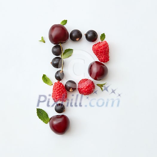 Letter P english alphabet in the form of a pattern of natural organic berries - ripe fresh raspberry, black currant, cherry, green mint leaf isolated on a white background. Top view.
