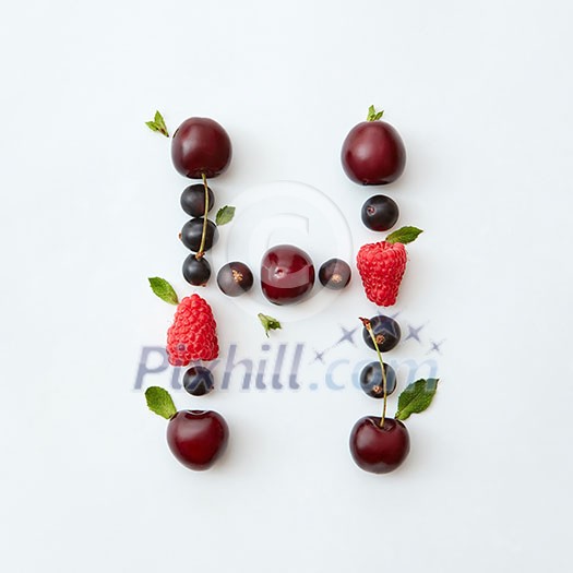 Letter H english alphabet in the form of a pattern of natural organic berries - ripe fresh raspberry, black currant, cherry, green mint leaf isolated on a white background. Top view.