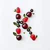 Letter K english alphabet in the form of a pattern of natural organic berries - ripe fresh raspberry, black currant, cherry, green mint leaf isolated on a white background. Flat lay
