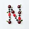 Letter N english alphabet in the form of a pattern of natural organic berries - ripe fresh raspberry, black currant, cherry, green mint leaf isolated on a white background. Flat lay