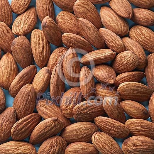Pile of almonds close-up as background. Almonds background.