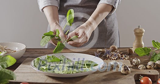 Slow motion video in 4K onto the close-up background with natural and organic ingredients for salad preparation on a wooden board. Delicious healthy organic food with proteins, nutrients and vitamins.