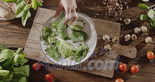 Top view, slow motion video in 4K onto the background with natural organic ingredients for salad preparation on a wooden board. Delicious healthy organic food with proteins, nutrients and vitamins.