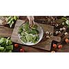 Top view, slow motion video in 4K onto the background with natural organic ingredients for salad preparation on a wooden board. Delicious healthy organic food with proteins, nutrients and vitamins.