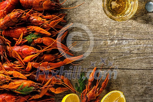 Fresh boiled crawfish with a mug of beer on a wooden table