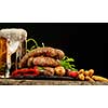 Grilled sausages with a glass of beer on a wooden table. Rustic style. Snacks for the Oktoberfest.