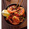 Large grilled BBQ shrimp with sweet chili sauce, green onion and lemon. Top view.
