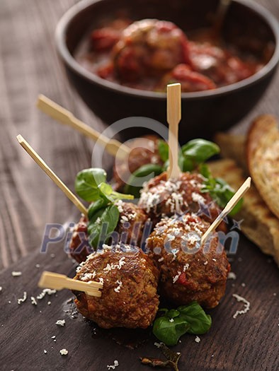 Delicious homemade meat balls with tomato sauce on skewers