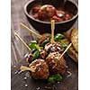 Delicious homemade meat balls with tomato sauce on skewers