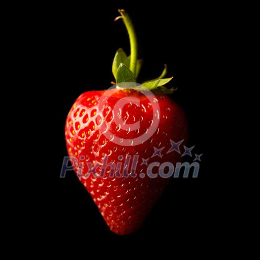 Ripe red strawberries on a black background. Shallow depth of field.