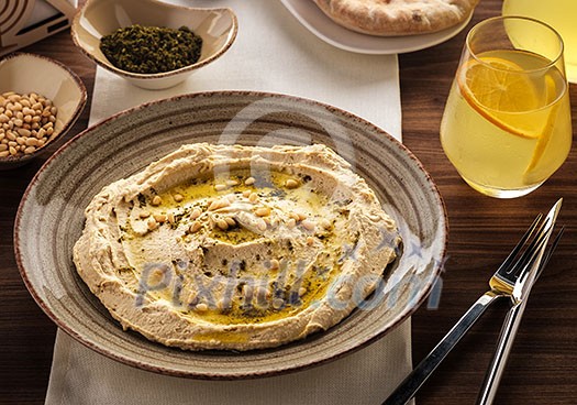 Delicious hummus with pine nuts and olive oil.