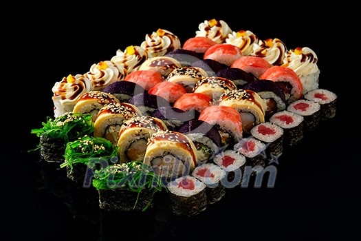 Fresh Sushi rolls set served on black background. Japanese seafood sushi. Fresh Sushi rolls set served on black background. Japanese seafood sushi.