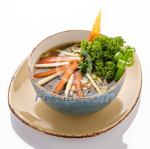 Plate of Vegetarian Soup Ramen with noodles and fresh herbs. Isolated on white background.