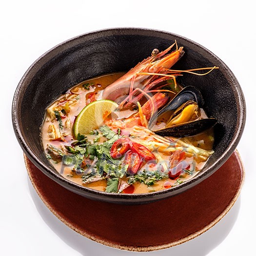 Plate of traditional Thai soup 'Tom Yam' with shrimps. Isolated on white background. Plate of traditional Thai soup 'Tom Yam' with shrimps. Isolated on white background.