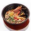 Plate of traditional Thai soup 'Tom Yam' with shrimps. Isolated on white background.