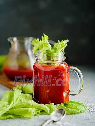 Tomato juice in mason jar with celery and salt
